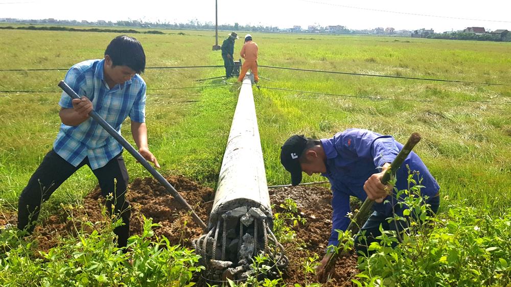 Sửa chữa một trụ điện bị gãy đôi tại huyện Bố Trạch. Ảnh: Lê Phi Long