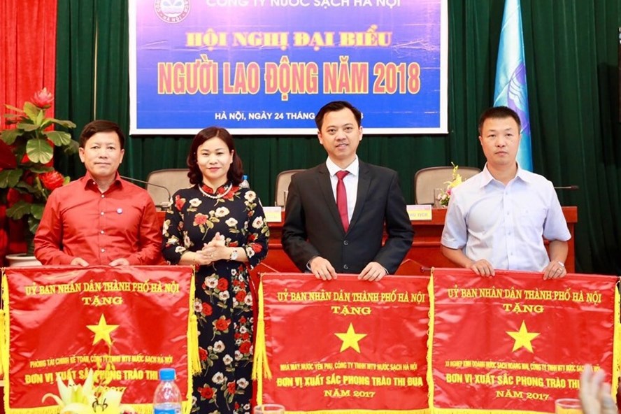 Bà Nguyễn Thị Tuyến - Ủy viên Đoàn Chủ tịch Tổng LĐLĐVN, Chủ tịch LĐLĐ TP. Hà Nội trao Cờ thi đua của UBND TP. Hà Nội tặng thưởng các tập thể Cty TNHH MTV Nước sạch Hà Nội. Ảnh: Nguyễn Thế Thiệu