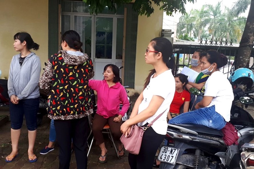 Giáo viên hợp đồng tập trung cạnh UBND huyện Thanh Oai để chờ lời giải thích thỏa đáng từ lãnh đạo huyện. Ảnh: Đình Tuệ.