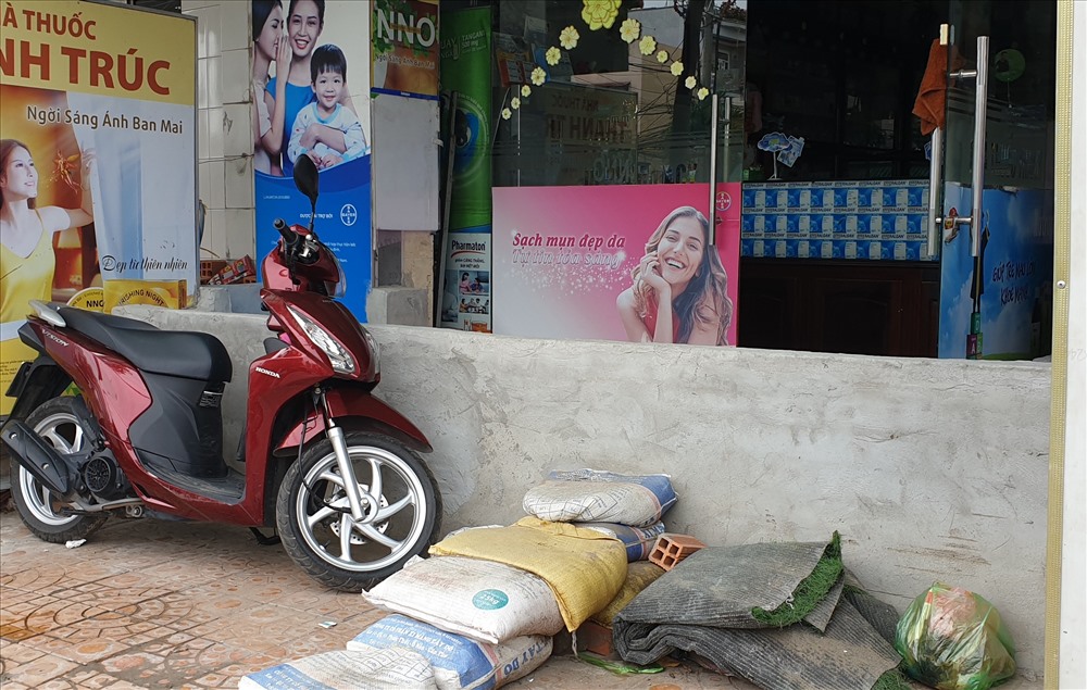 Người dân xây “lô cốt” trước cửa hàng cao gần cả mét so với mặt đường để ngăn triều cường gây thiệt hại. Ảnh: H.Thơ.