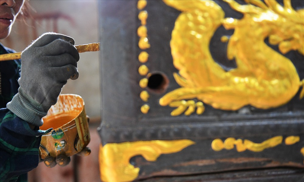 Mỗi người một công đoạn. Có người chỉ lo tô lại màu các họa tiết.
