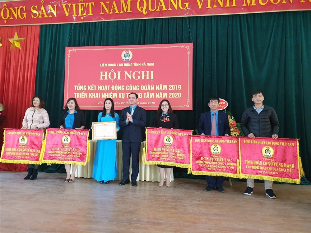 Đồng chí Nguyễn Đình Khang - Ủy viên Ban Chấp hành Trung ương Đảng, Chủ tịch Tổng LĐLĐVN - trao Cờ thi đua xuất sắc cho các đơn vị.