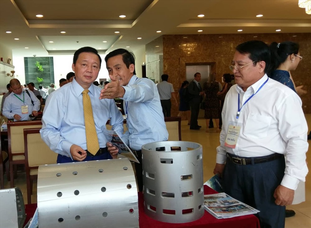 Bộ trưởng Bộ TN&MT - Trần Hồng Hà (bìa trái) tham quan mô hình đề chắn sóng biển bên hành lang hội thảo. Ảnh: Minh Quân