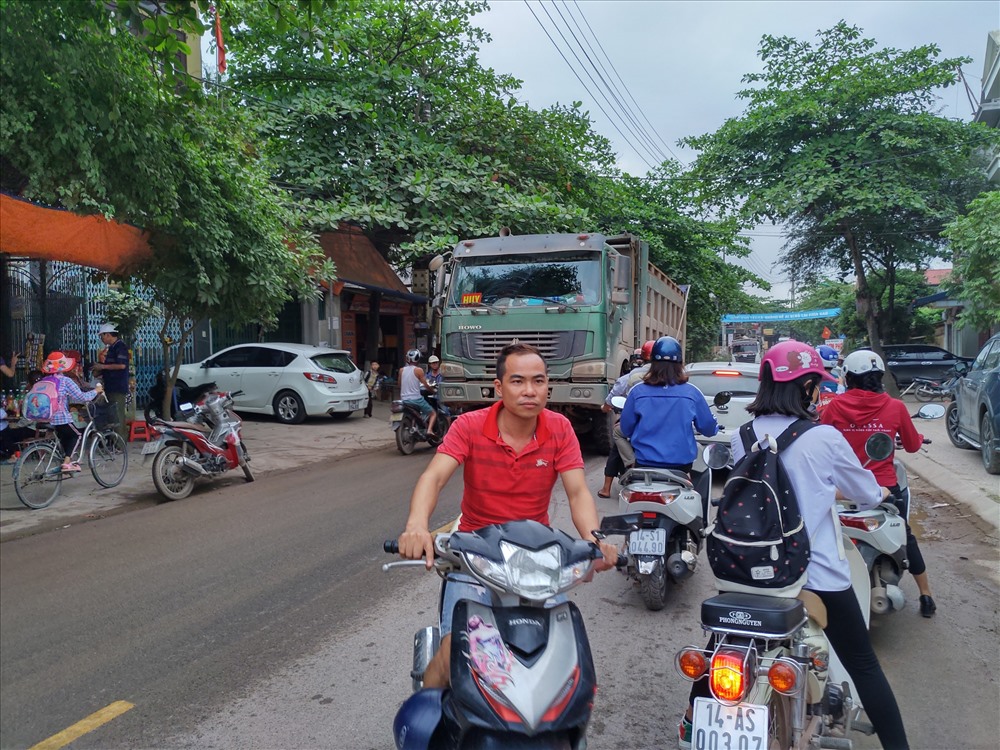 Người dân ở đây phải luôn phải hứng chịu tiếng ồn, bụi bẩn và mất an toàn giao thông từ những chiếc xe Howo chở đất đá. Ảnh: T.N.D