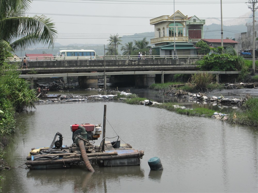 Một con suối ở TP. Cẩm Phả luôn trong tình trạng nhuốm màu đen do than từ các mỏ lộ thiên trôi xuống. Con suối này nằm cách vịnh Bái Tử Long không xa. Ảnh: Nguyễn Hùng