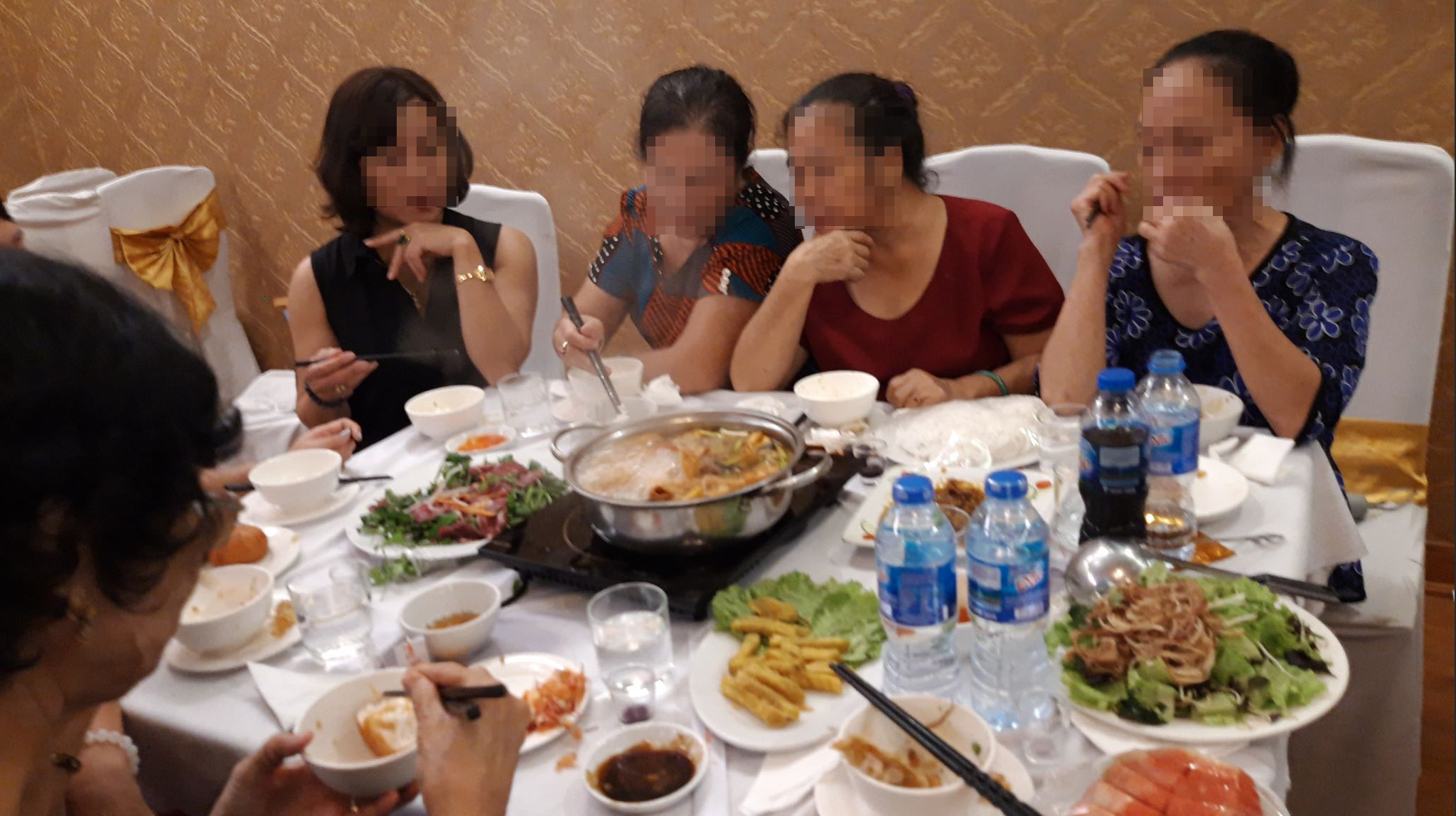Một nữ môi giới ngồi ngoài cùng bên trái, đang lôi kéo người chơi trong khi ăn.