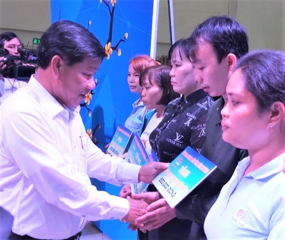 Ông Trần Thanh Liêm, Chủ tịch UBND tỉnh Bình Dương, trao tượng trưng quà cho các CNLĐ có hoàn cảnh khó khăn. Ảnh Nam Dương