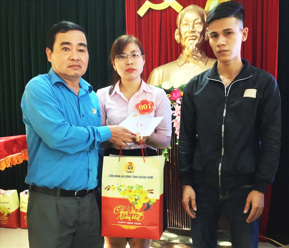 Chủ tịch LĐLĐ tỉnh Quảng Nam Phan Xuân Quang (đứng bên trái) trao quà Tết cho đoàn viên có hoàn cảnh khó khăn.
