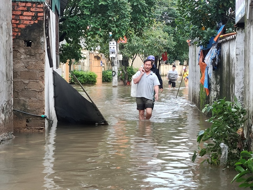 Người dân tại tổ dân phố 5, phường Nam Hà, TP. Hà Tĩnh thu dọn đồ đạc chuyển đến nơi cao ráo. Ảnh: Quách Du