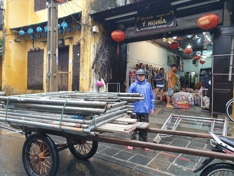 Nước lũ không ngừng dâng lên khiến nhiều người dân, các hộ kinh doanh ở phố cổ Hội An hối hả dọn đồ đạc đưa lên cao.