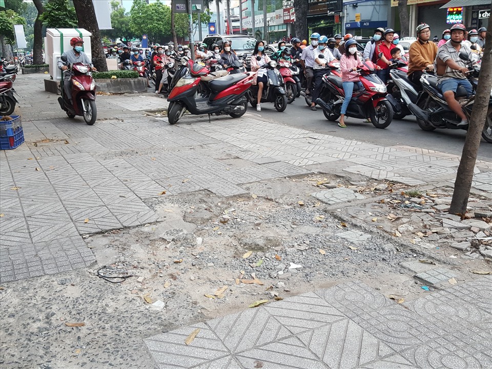 Nhiều điểm trên vỉa hè đường 3 tháng 2 xuống cấp vì xe máy di chuyển thường xuyên vào giờ cao điểm. Ảnh: Hữu Huy