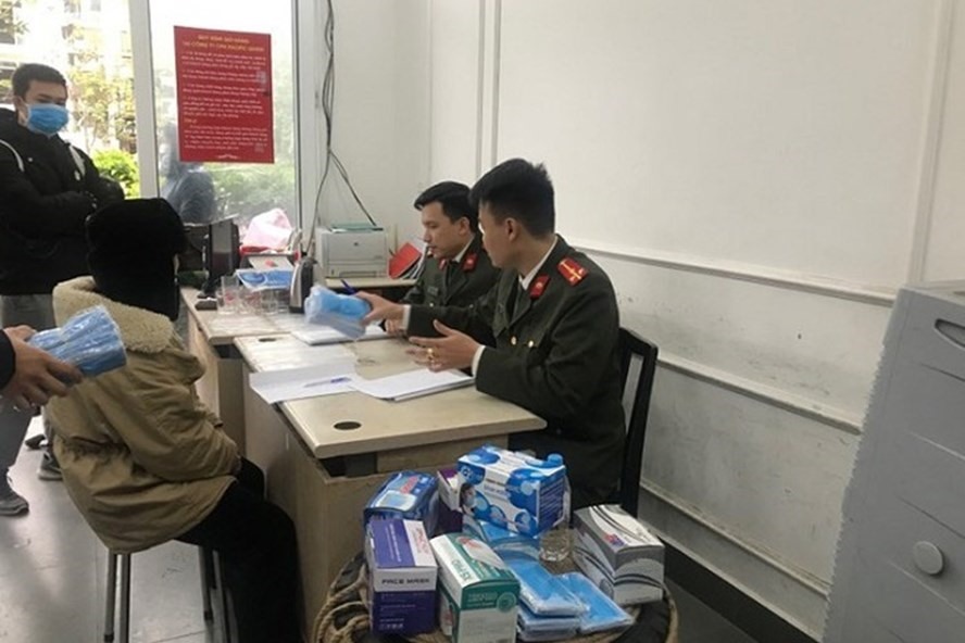 Lực lượng chức năng làm việc với những người liên quan đến lô khẩu trang. Ảnh: LN