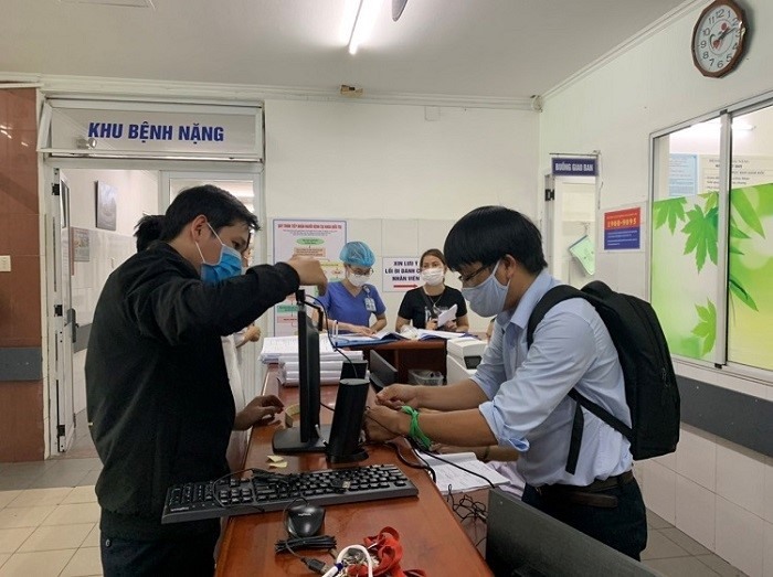 Nhóm sáng kiến Công đoàn Công ty Công nghệ thông tin thuộc TCty Điện lực miền Trung đang lắp đặt Ứng dụng nhận diện khuôn mặt phát hiện, cảnh báo các trường hợp không đeo khẩu trang hoặc đeo khẩu trang không đúng cách”. Ảnh: Trần Tuấn