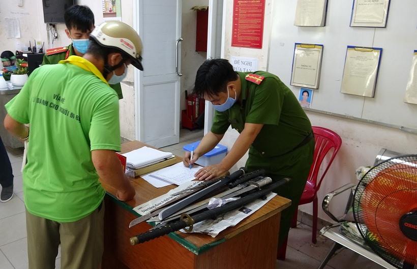 Người dân đến giao nộp vũ khí thô sơ. Ảnh: CACC.