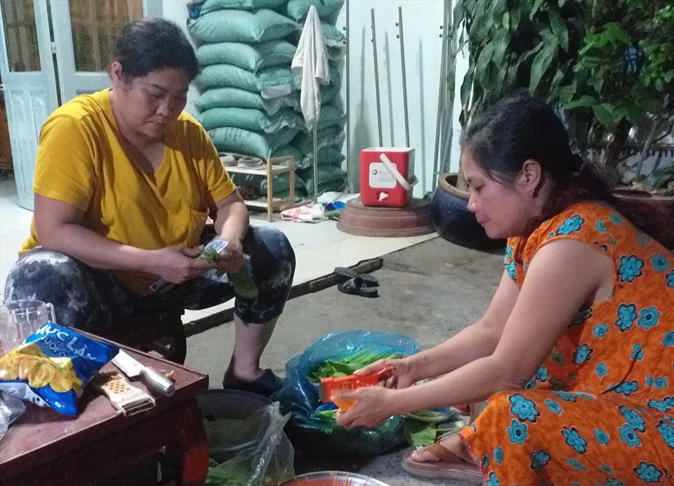 Chị Ngọc (người mặc áo vàng) đang lặt, cắt rau củ quả để làm món bún xào chay. Chị Ngọc (người mặc áo vàng) đang lặt, cắt rau củ quả để làm món bún xào chay.
