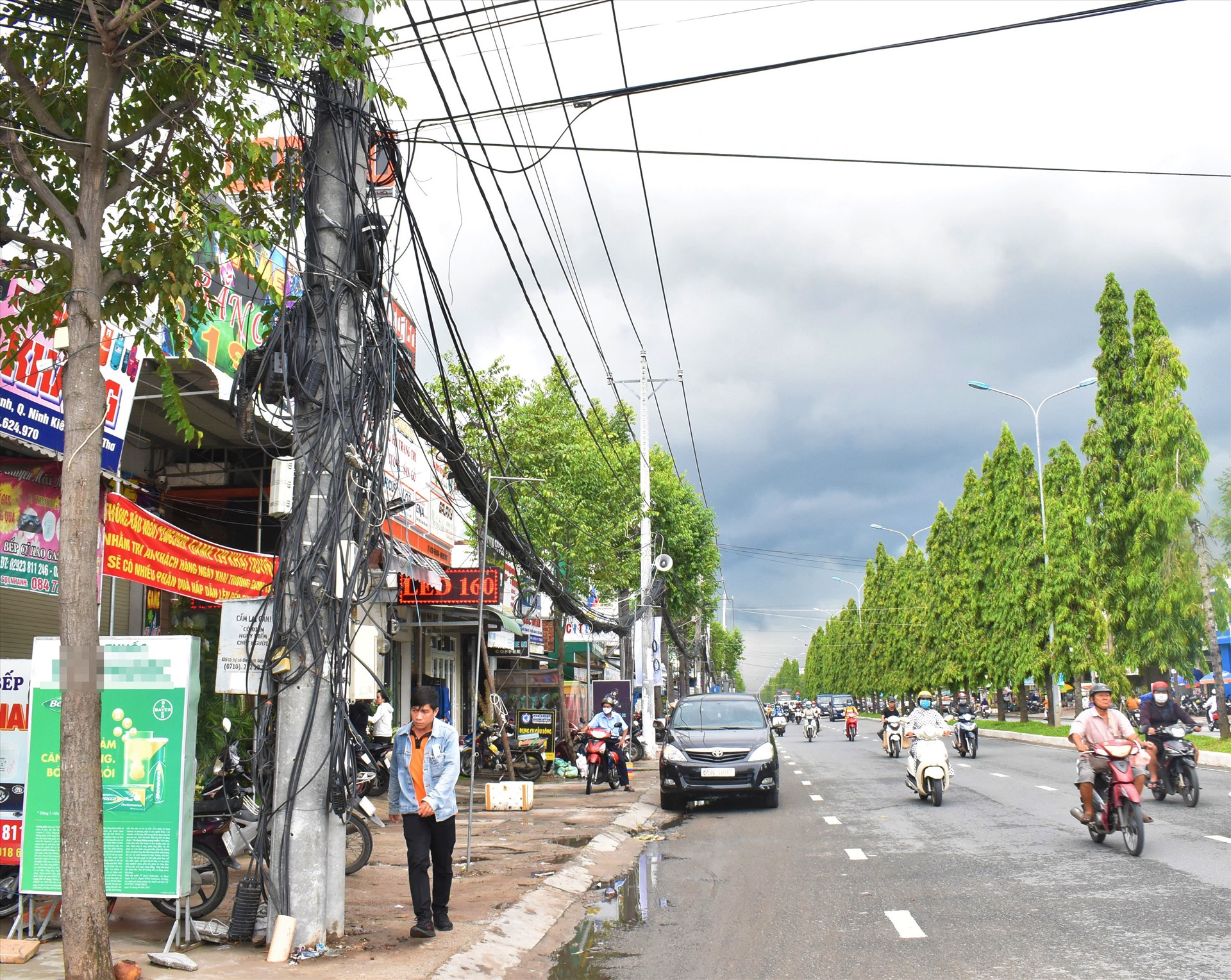 Dây cắp viễn thông không gọn ràng, sà xuống tới mặt đường thấp tới tầm người đi bộ gay nguy cơ tiềm ẩn nguy hiểm cho người đi bộ là rất lớn đặc biệt trong mùa mưa. Ảnh: Thành Nhân