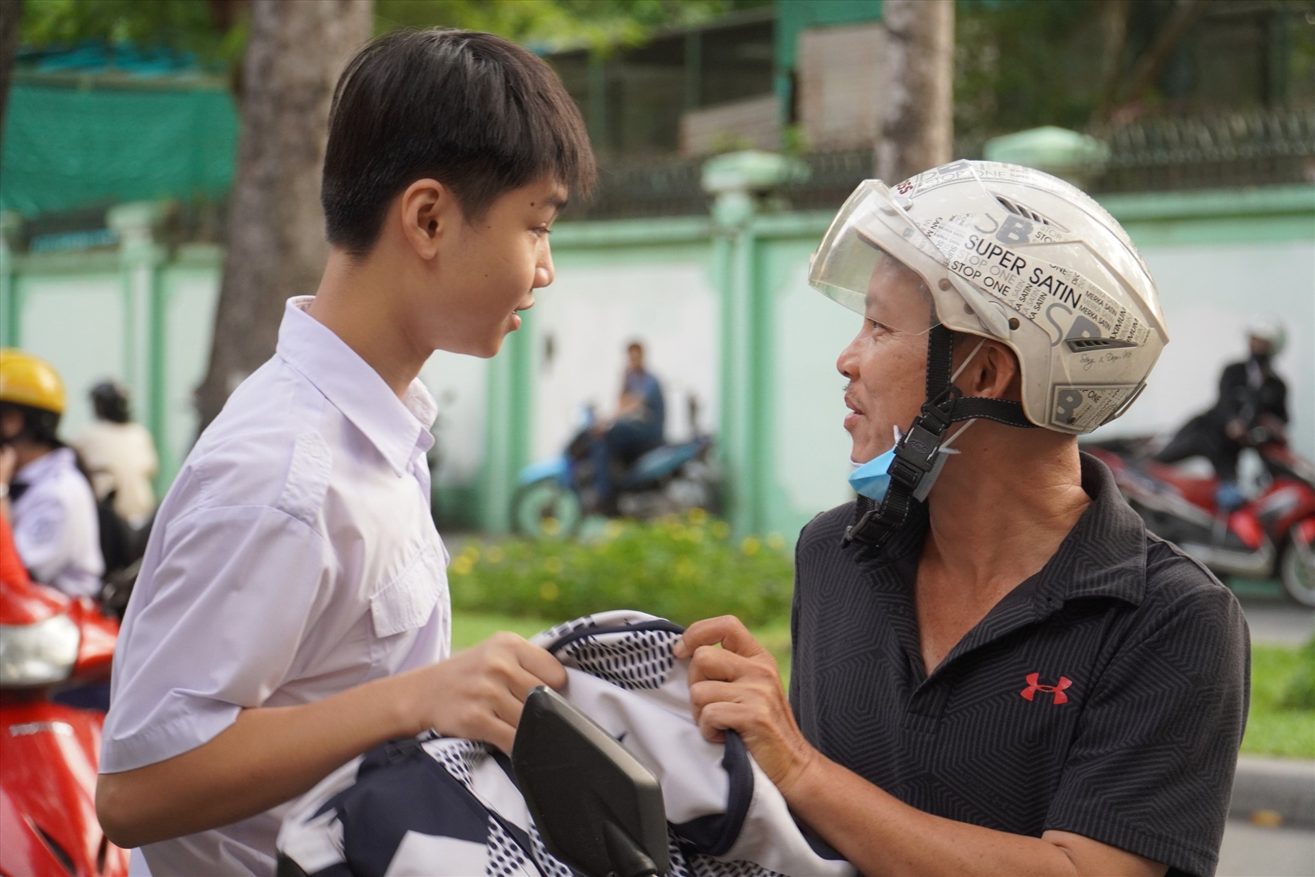 Phụ huynh ân cần dặn dò con trước khi vào phòng thi. Ảnh: Chân Phúc