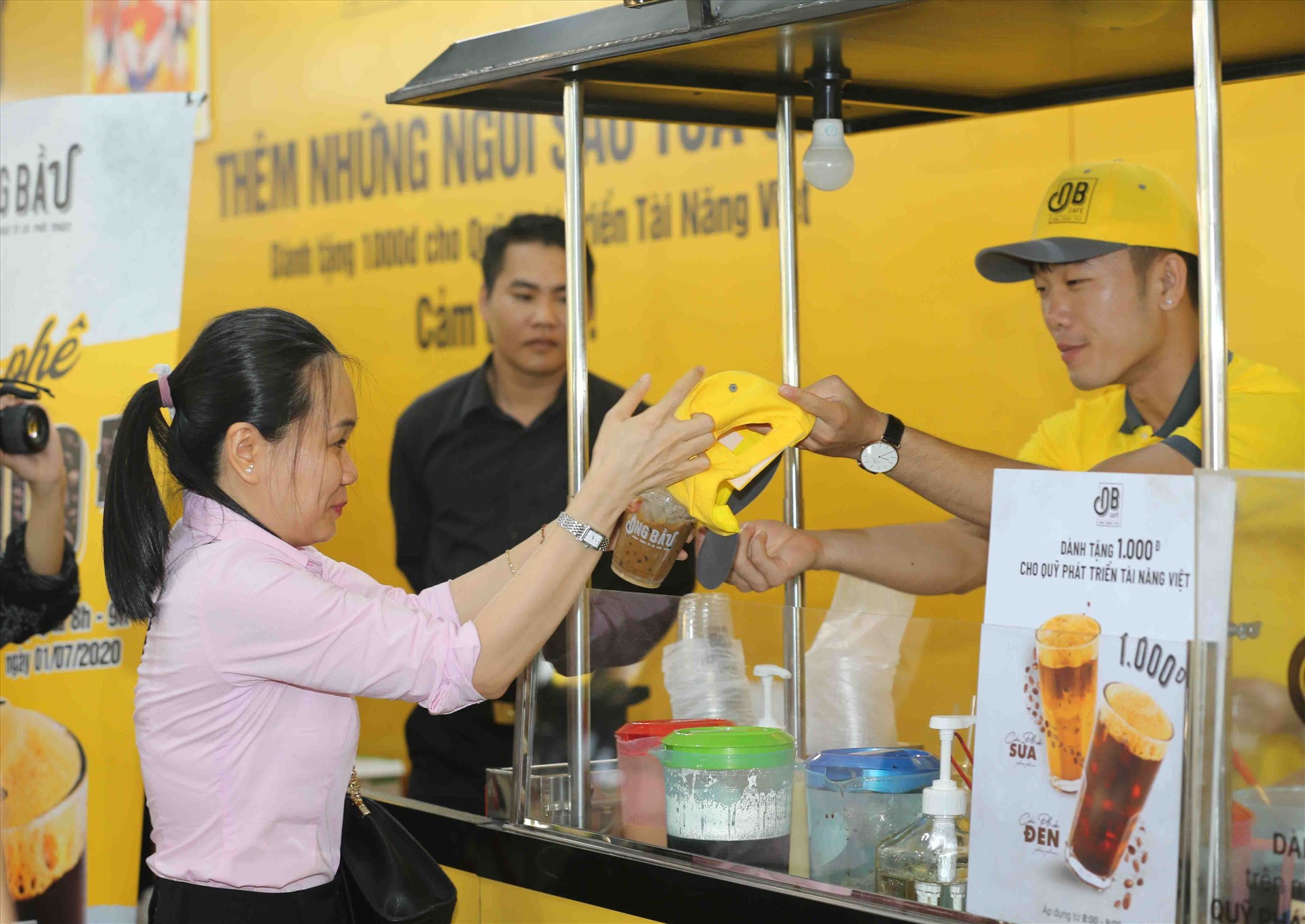 Xuân Trường pha cà phê và tặng nón cho người hâm mộ.