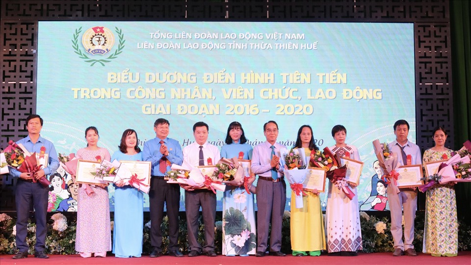 Ông Phan Văn Anh (thứ 4, trái sang) - Phó Chủ tịch Tổng LĐLĐ Việt Nam và ông Bùi Thanh Hà (thứ 5, phải sang) - Phó Bí thư Thường trực Tỉnh ủy Thừa Thiên Huế tặng hoa và bằng khen cho những tập thể, cá nhân điển hình tiên tiến. Ảnh: P. Đạt.