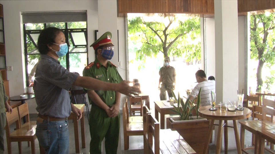 Công an thành phố Huế tuyên truyền các biện pháp phòng chống dịch tại một quán cà phê. Ảnh: CA cung cấp.