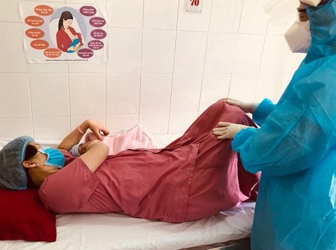 Bác sĩ Khoa Phụ sản hỏi thăm sức khỏe mẹ con sản phụ sau khi sinh. Ảnh: BV cung cấp.