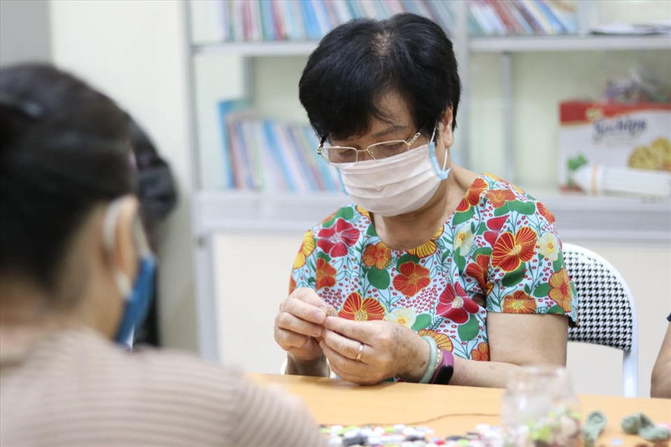 Mỗi ngày, bà Hoàng Thị Tình có thể đan móc được từ 30 - 40 chiếc băng cài khẩu trang. Ảnh: L. Nhi
