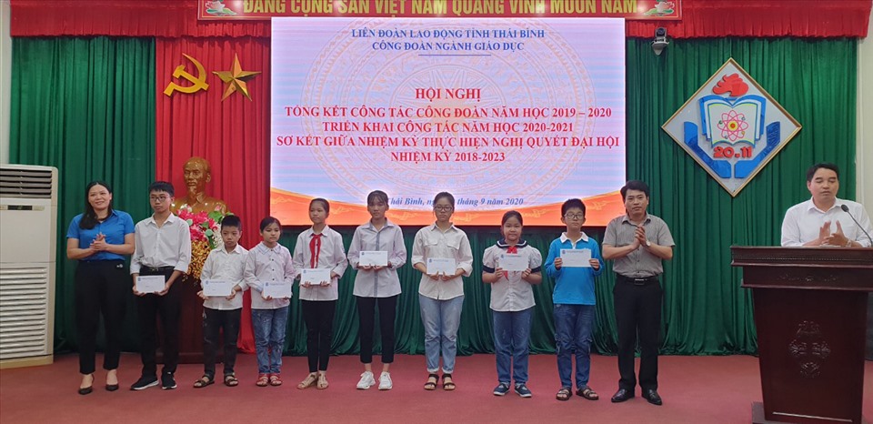 Lãnh đạo Sở giáo dục và đào tạo, LĐLĐ tỉnh trao 10 suất học bổng mỗi suất 500.000 đồng cho các em học sinh con đoàn viên vượt khó học giỏi. Ảnh: Bá Mạnh