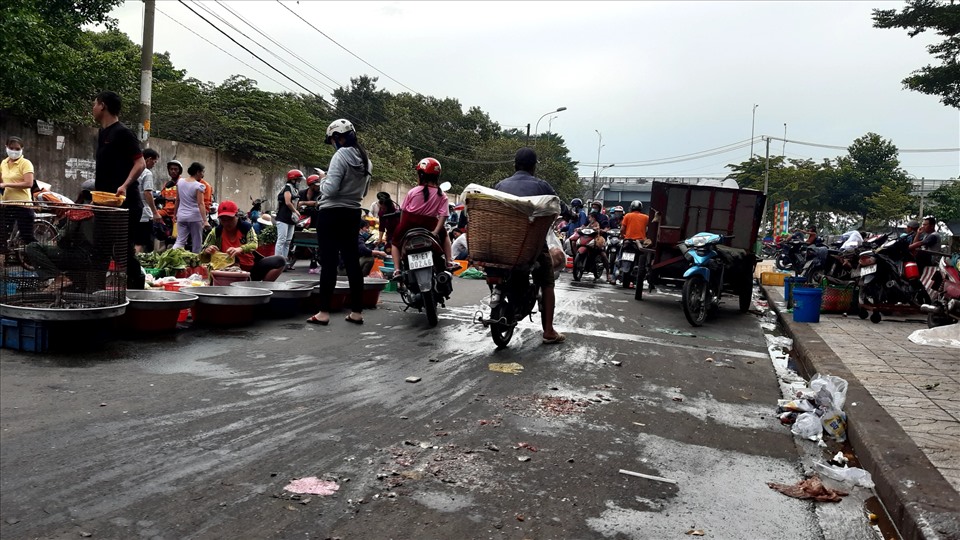 Người bán hàng bày bán kế bên nơi tập trung thu gom rác thải - Ảnh Nam Hiệp