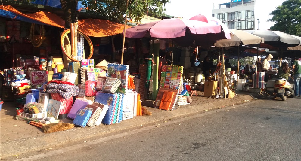 Tại đây, hàng loạt các cửa hàng kinh doanh đều dựng mái che, bày bán tràn lan các mặt hàng trên vỉa hè.