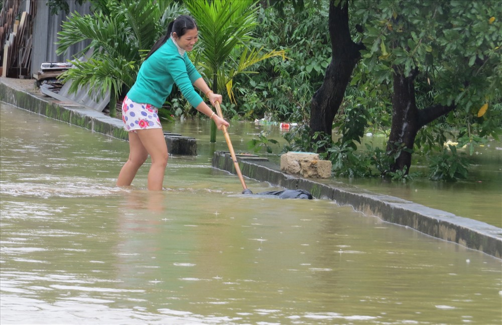 Dọc tuyến đường liên xã Tân Sơn Hòa, những nơi nước lũ đã rút, người dân bắt đầu dọn vệ sinh, di chuyển những túi rác nước lũ tấp về. Ảnh: Hưng Thơ.