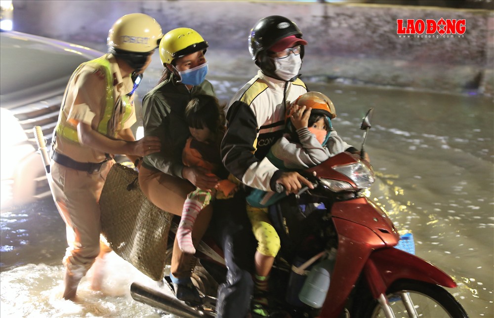 Sự hỗ trợ kịp thời của CSGT khiến người dân rất vui mừng. Trong ảnh là một gia đình nhỏ đang nhận được sự giúp đỡ của một CSGT thuộc Trạm CSGT Tân Túc. Ảnh: Trường Sơn