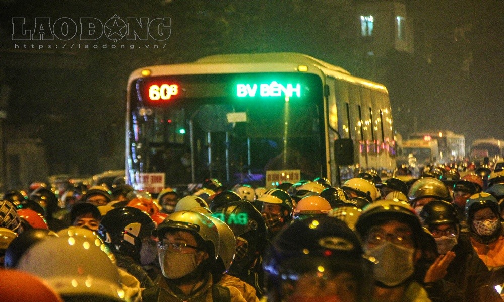 Một chiếc ô tô bị bao vây bởi hàng nghìn xe máy.