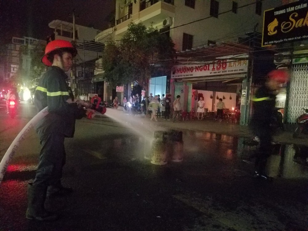 Một trong số các bình ga được đưa ra khỏi đám cháy đâng được làm lạnh.Ảnh: P.L