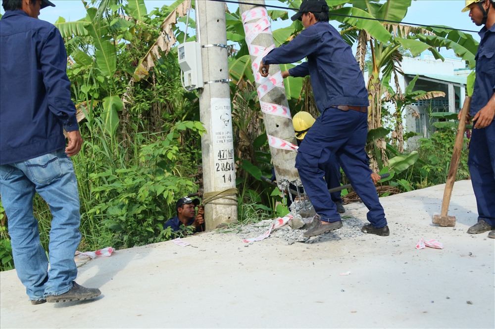 Công việc đập bỏ các trụ điện được tiến hành một cách nhanh chóng và khẩn trương nhằm tránh gây ách tắt giao thông. Ảnh: BT