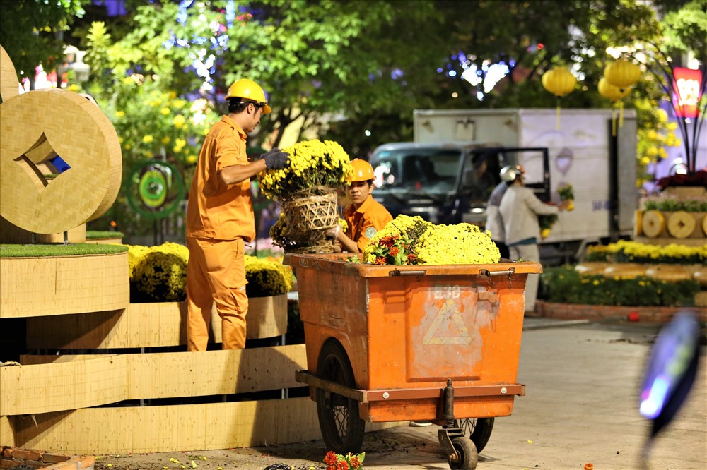 Công nhân khẩn trương tháo dỡ các tiểu cảnh tranh trí trên đường hoa. Ảnh: Trường Sơn