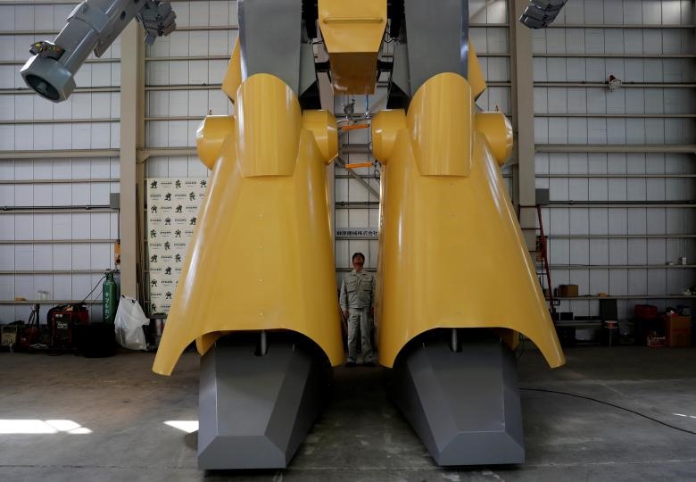 Kỹ sư Masaaki Nagumo đang chờ một chiếc cáp để lên buồng điều khiển của con robot. (Ảnh: REUTERS)