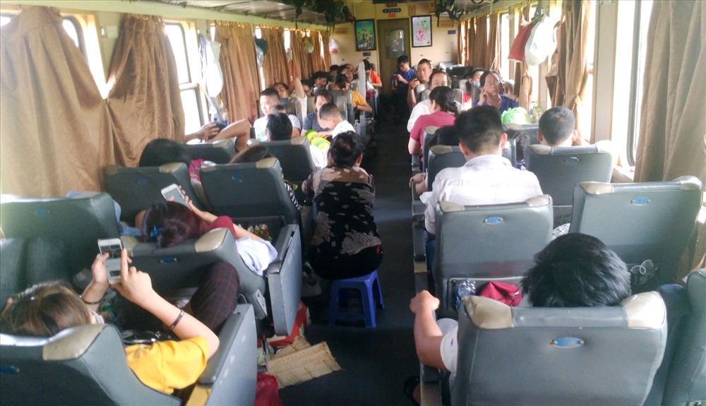 Các toa trên tàu SE8 đều kín chỗ. Một số người phải ngồi ghế phụ hoặc đường nối giữa 2 toa tàu. Ảnh: ST