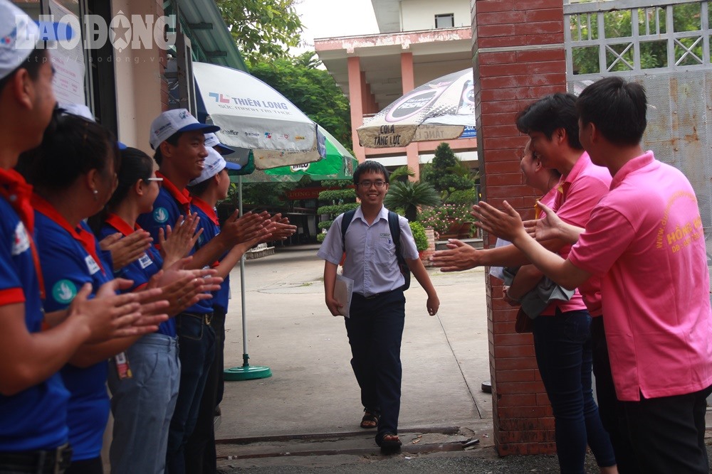 ảnh 6: Trước tràng pháo tay chờ đón của các thầy cô giáo, em Châu Đặng Quốc Trung, học sinh trường THPT Hồng Hà là thí sinh đầu tiên rời phòng thi trong tâm thế thoải mái, hồ hởi.