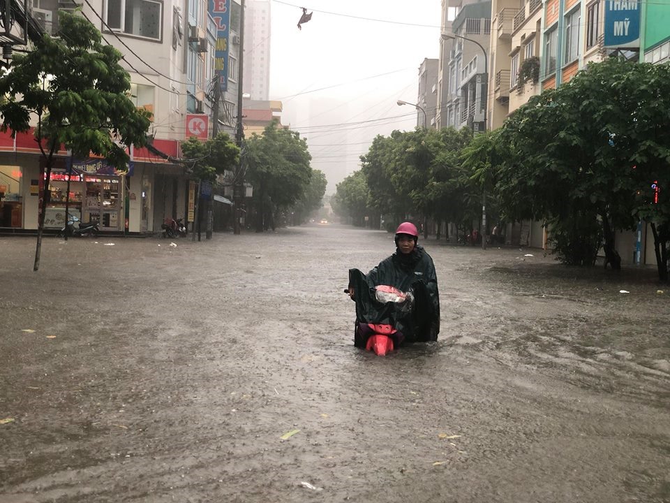 Người dân mướt mải dắt xe, lội phố ngập sâu.
