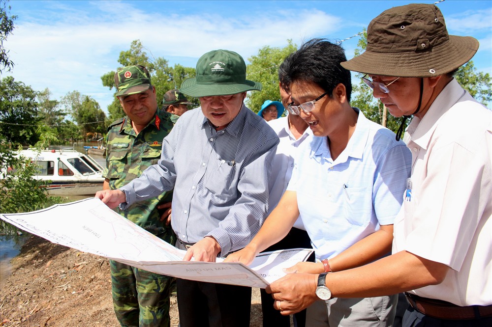Phó Bí thư Thường trực Tỉnh ủy, Chủ tịch HĐND tỉnh An Giang Võ Anh Kiệt (thứ 2 trái sang) trực tiếp đến xã Vĩnh Phước (Tri Tôn) nắm tình hình và động viên lực lượng bảo vệ đê. Ảnh: Lục Tùng
