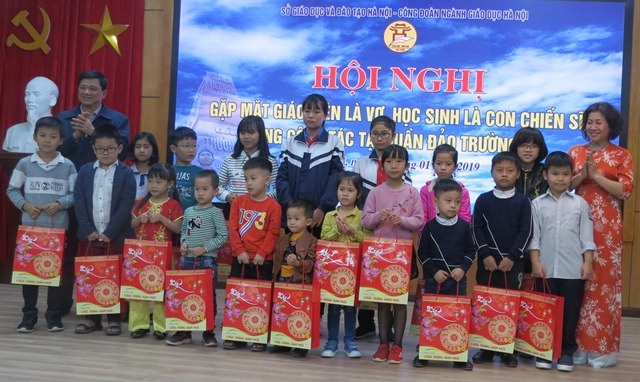 Bà Trần Thị Thu Hà - Chủ tịch CĐ Giáo dục Hà Nội và ông Phạm Xuân Tiến - Phó Giám đốc Sở Giáo dục TP. Hà Nội trao quà cho các học sinh là con cán bộ, chiến sĩ công tác tại quần đảo Trường Sa. Ảnh: Xuân Trường