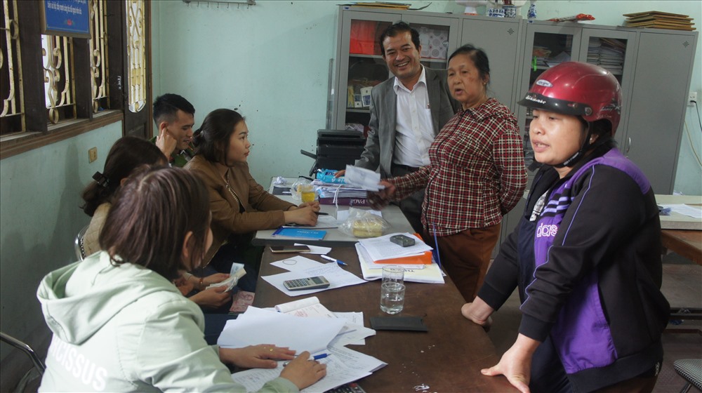 Các hộ kinh doanh vui vẻ nhận tiền hỗ trợ