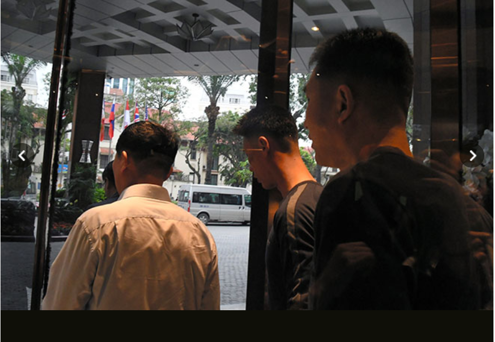 Vệ sĩ Triều Tiên ra khỏi một khách sạn ở Hà Nội và tránh mọi câu hỏi của phóng viên. Ảnh: Asahi.