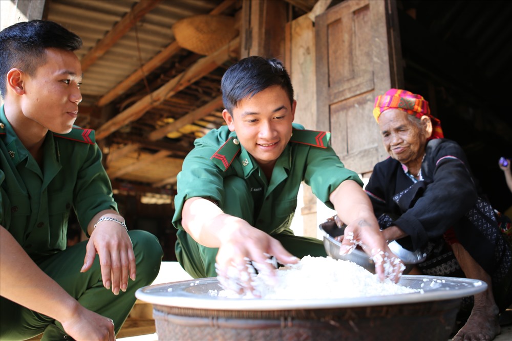 Chiến sĩ biên phòng cùng người dân làm mâm cơm đón tết. Ảnh: Hưng Thơ.