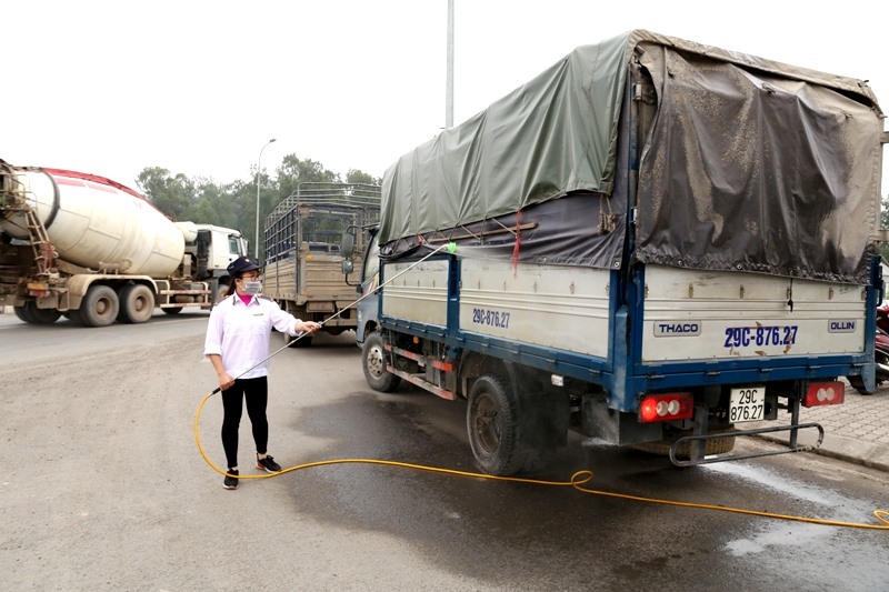 Xe ra vào đều phải phun hóa chất tiêu độc khử trùng. Ảnh: Minh Long