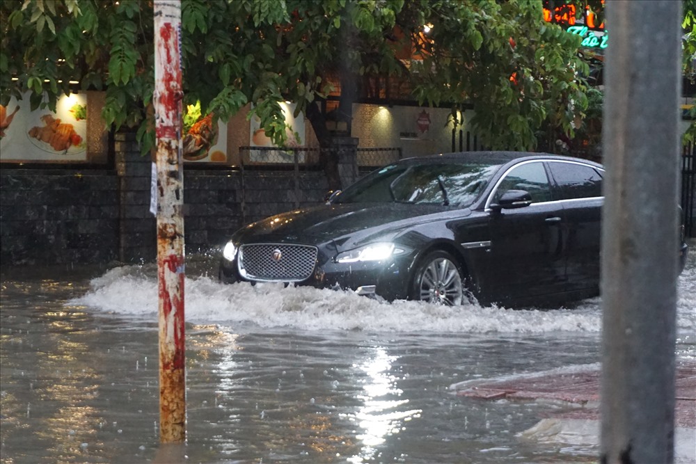 Một chiếc ô tô hạng sang lội nước trong khu nhà giàu Thảo Điền.